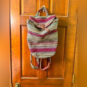 Cute Boho backpack with fold over buckled feature. Missing grommets and torn.